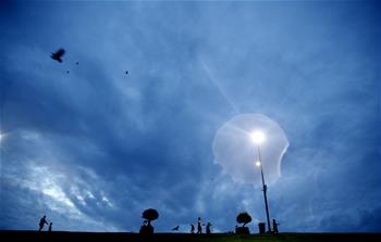 People do morning exercises on bank of Inya Lake in Yangon, Myanmar