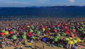 People cool off at Dameisha Beach Seashore Park in China's Guangdong